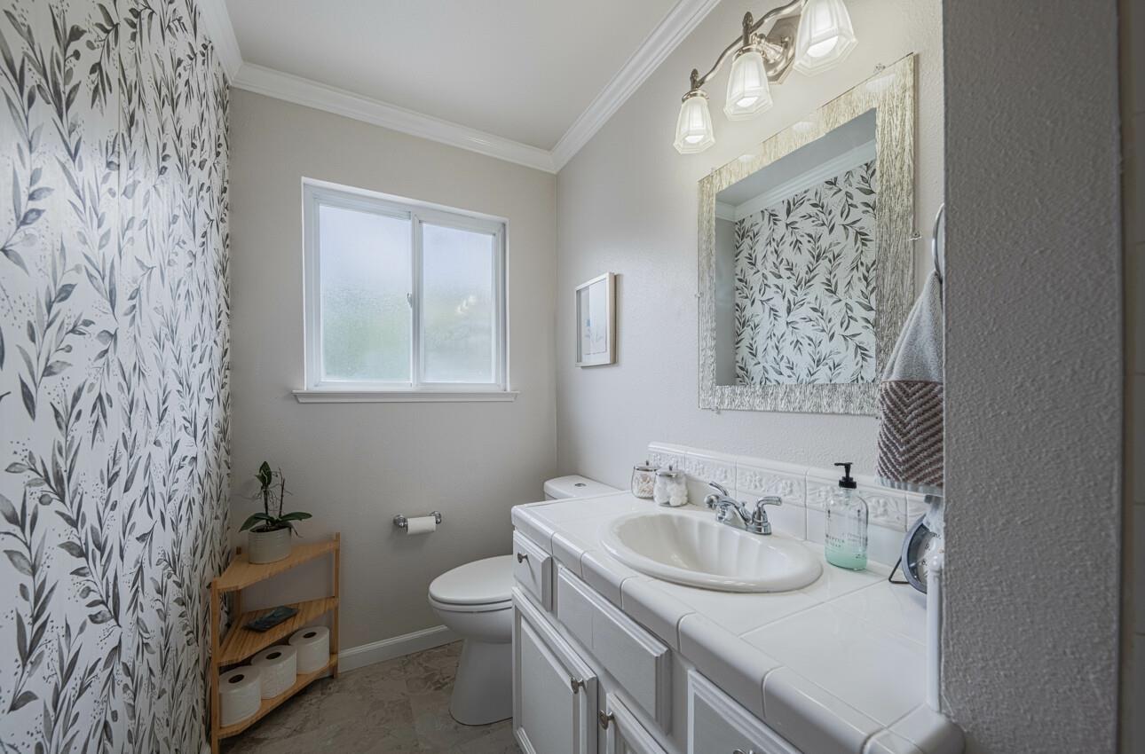 715 Vía Maria Salinas, CA 93901 - Photo 11 of 14 a bathroom with a sink a toilet and a mirror