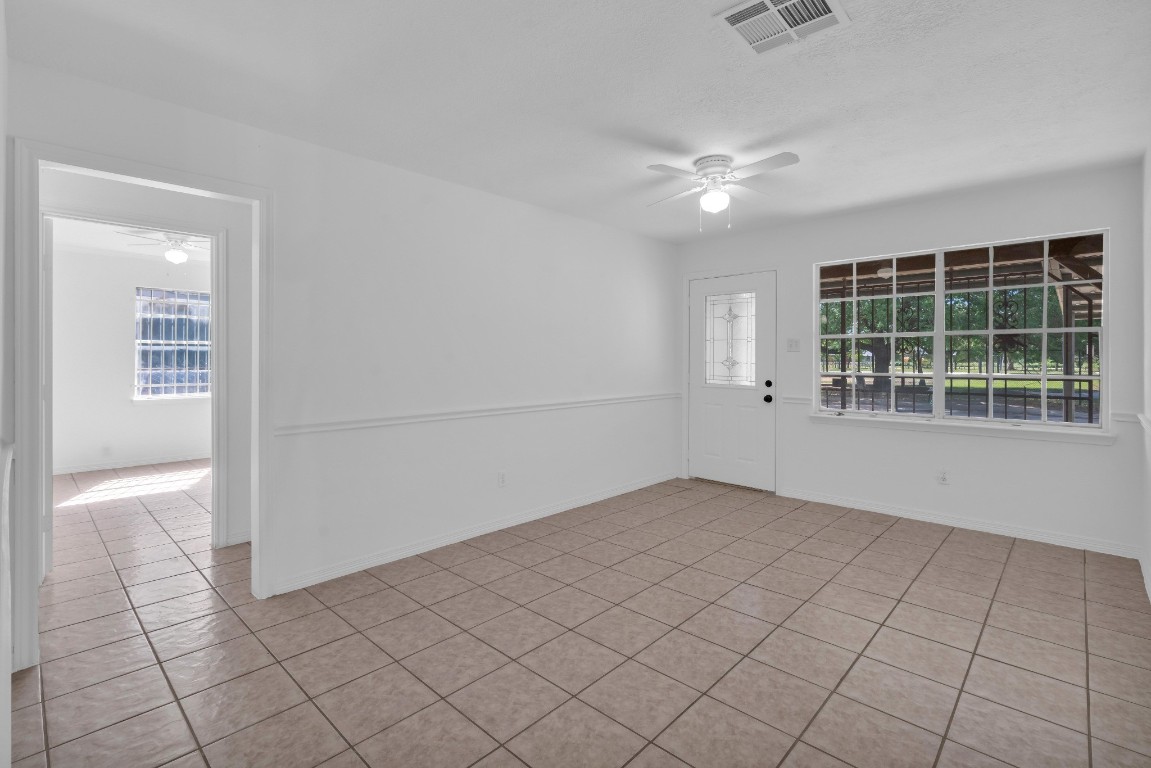 3922 Simsbrook Drive Houston, TX 77045 - Photo 12 of 32 View of the living room from the kitchen, toward the home's main entry. Primary Bedroom entrance shown to the left.