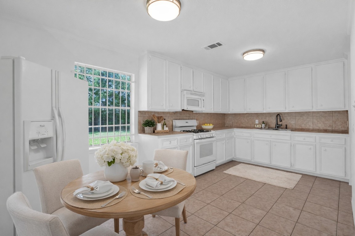 3922 Simsbrook Drive Houston, TX 77045 - Photo 6 of 32 Plenty of cabinets in the Kitchen! All with new paint and door pull.