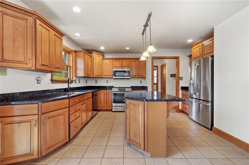 543 Birch Drive Houston, PA 15342 - Photo 14 of 48 a kitchen with stainless steel appliances granite countertop a refrigerator and a stove top oven