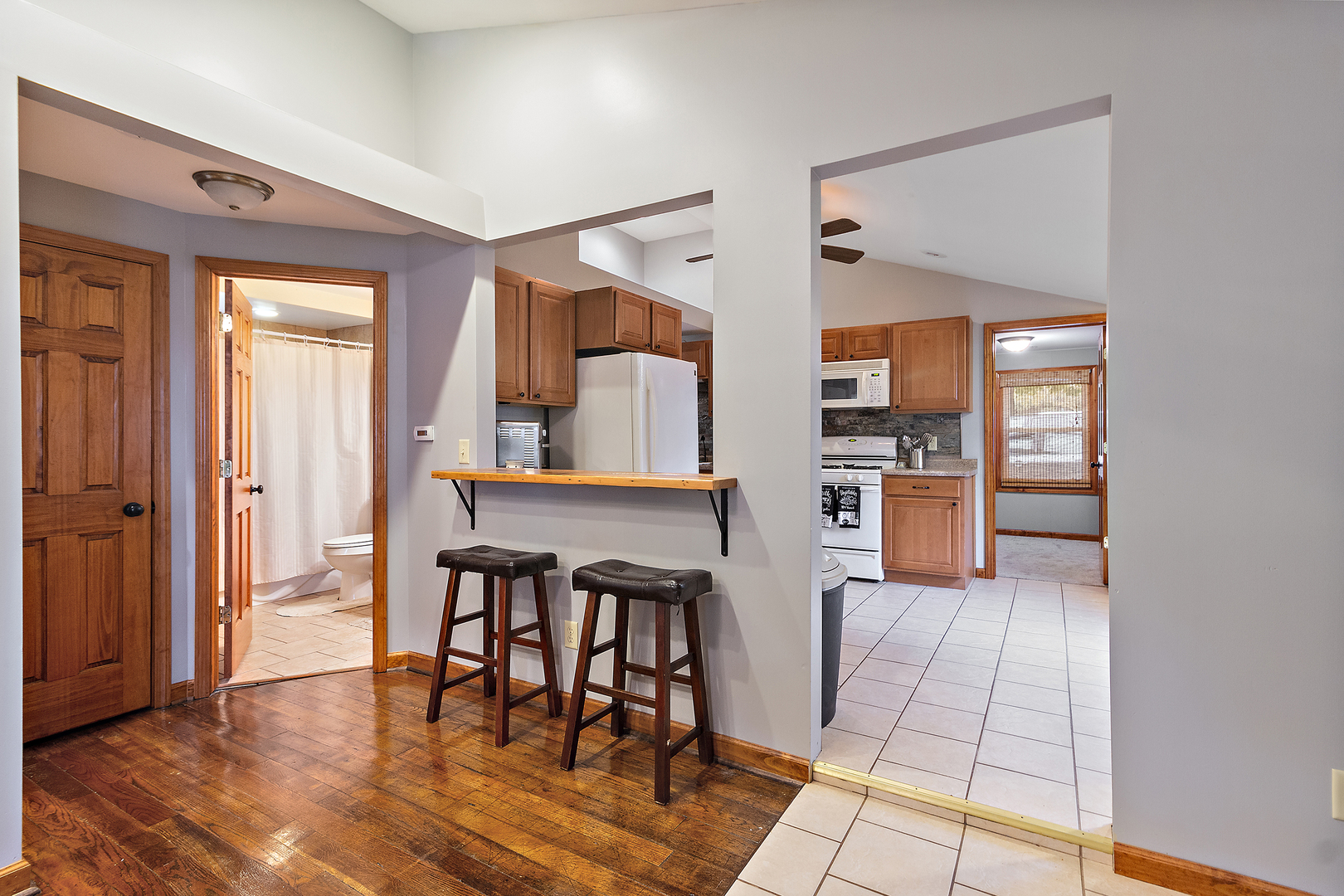 3100 Sportsman Club Road Bourbonnais, IL 60914 - Photo 6 of 15 a kitchen with stainless steel appliances granite countertop a stove top oven a sink dishwasher and a dining table with wooden floor
