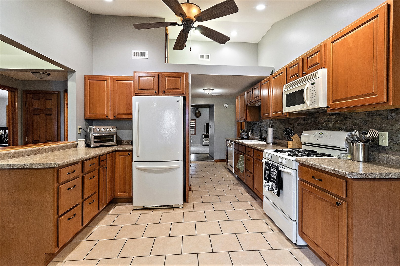 3100 Sportsman Club Road Bourbonnais, IL 60914 - Photo 7 of 15 a kitchen with stainless steel appliances granite countertop a refrigerator a stove top oven a sink and dishwasher
