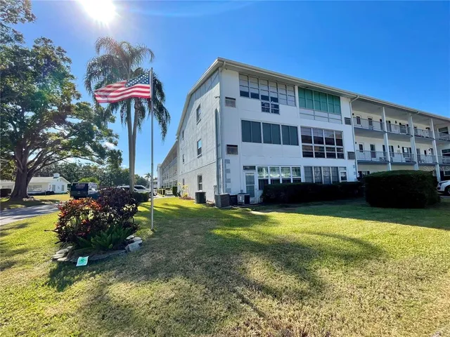a view of a house with swimming pool and sitting area