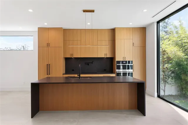 a kitchen with stainless steel appliances a sink and a refrigerator