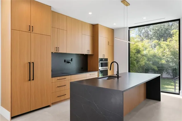 a kitchen with sink and cabinets