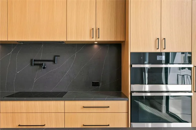 a kitchen with kitchen island a sink appliances and a large window