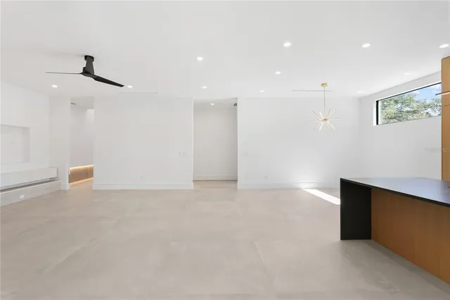 a bathroom with a granite countertop sink a bathtub and a window