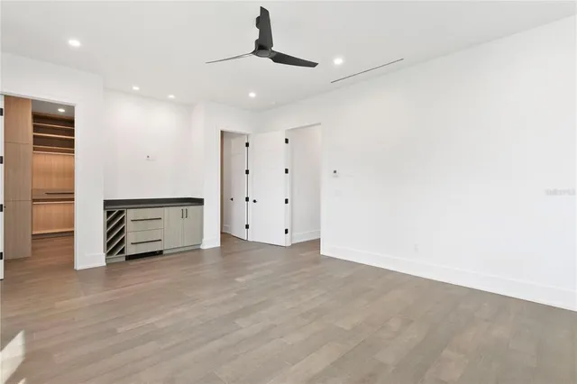 a view of a room with wooden floor