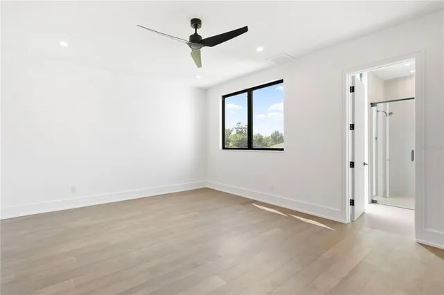 a bathroom with a granite countertop sink and a toilet
