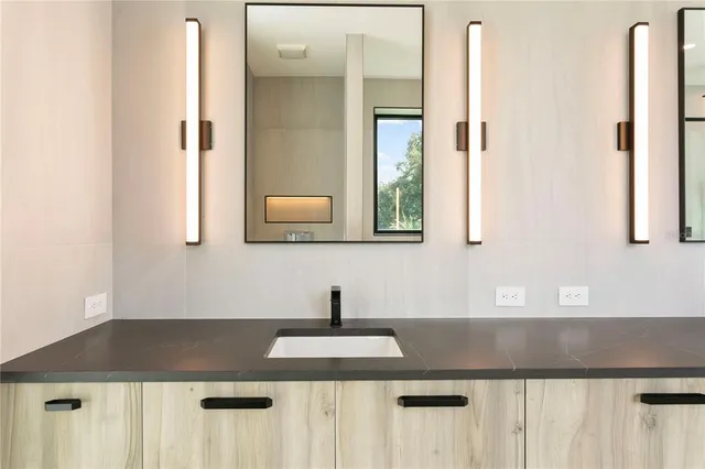 an empty room with wooden floor ceiling fan and windows