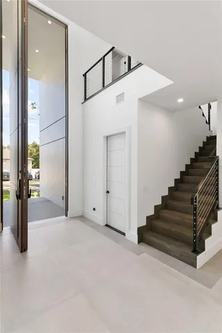 an empty room with an entryway and a chandelier