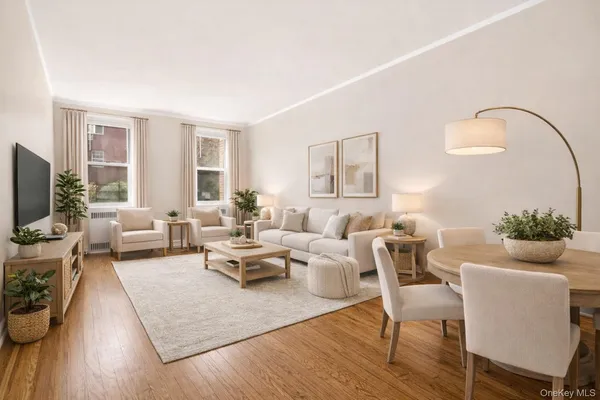 a living room with furniture wooden floor and a large window