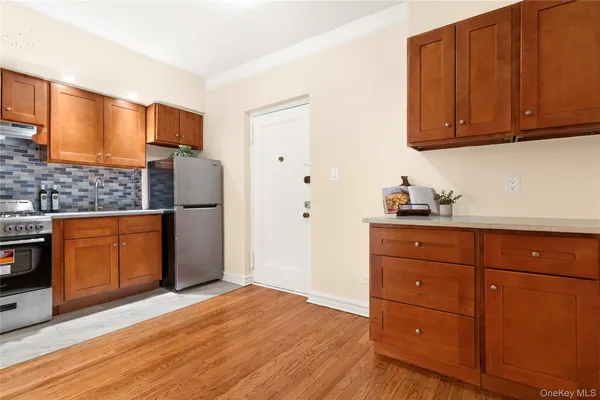 a kitchen with stainless steel appliances granite countertop a refrigerator and cabinets