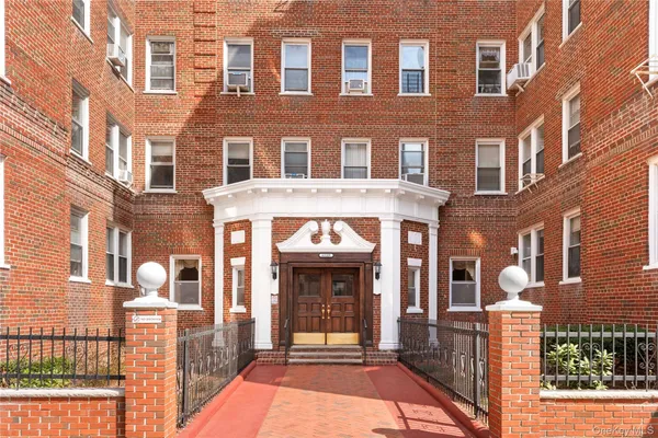a front view of a brick building with a large windows