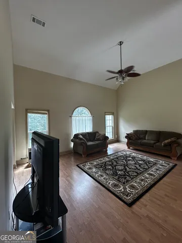 a living room with furniture rug and window