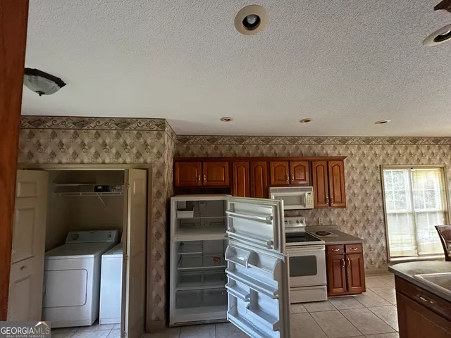 a kitchen with stainless steel appliances kitchen island granite countertop a stove and a refrigerator