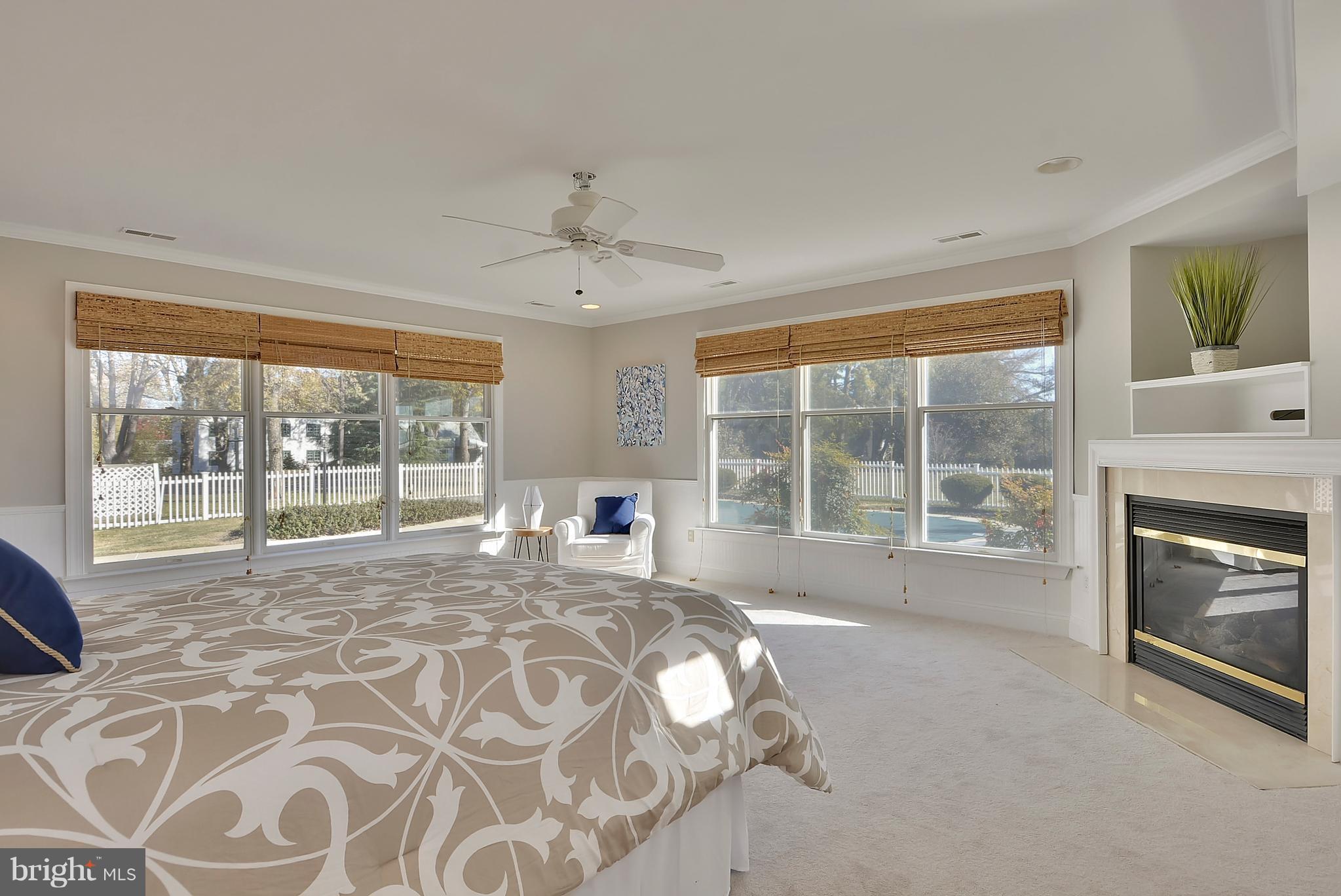 104 Thompson Road Chester, MD 21619 - Photo 19 of 29 Master Bedroom with fireplace and access to pool