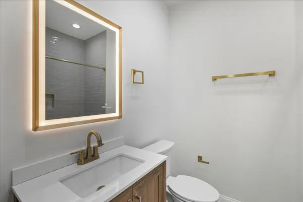 a bathroom with a sink vanity and toilet