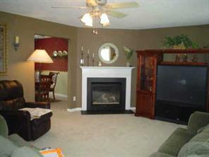 2081 Chapel Creek Road Concord, NC 28025 - Photo 4 of 8 a living room with furniture a fireplace and a flat screen tv