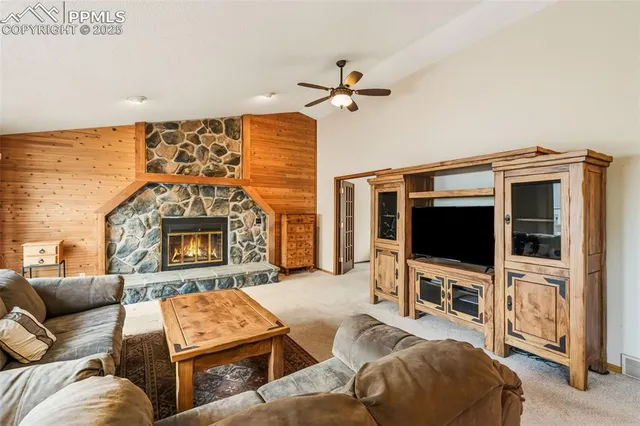a living room with furniture a flat screen tv and a fireplace