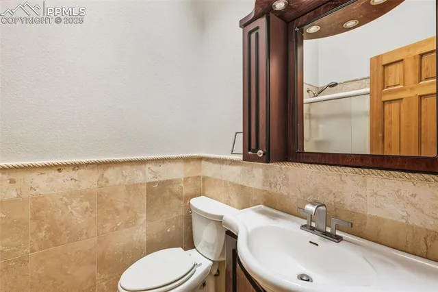 a bathroom with a sink toilet and mirror