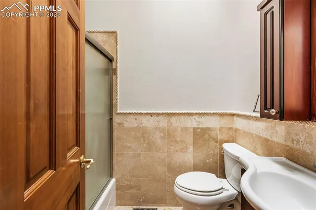 a white toilet sitting next to a bathroom sink
