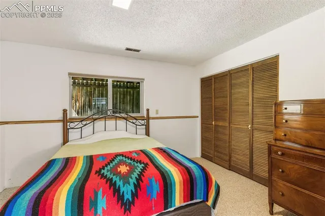 a bedroom with a bed and a table