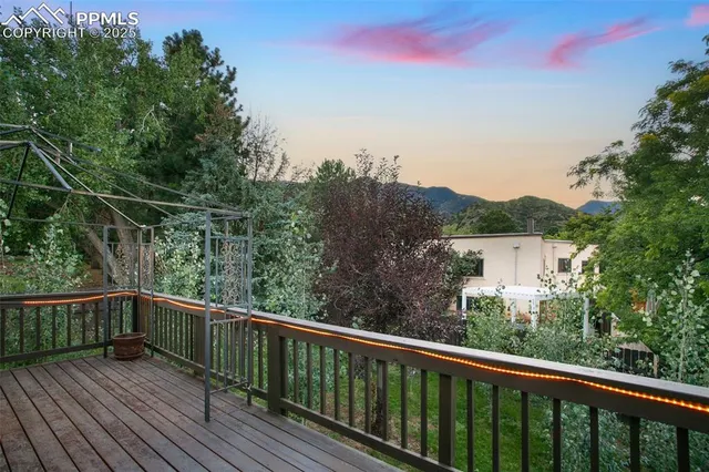a view of a balcony with wooden floor and fence