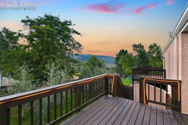 a view of balcony with wooden floor and fence