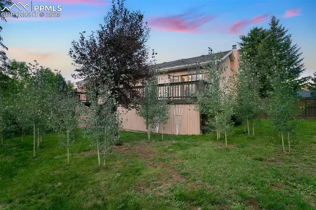 a view of an house with backyard space and garden