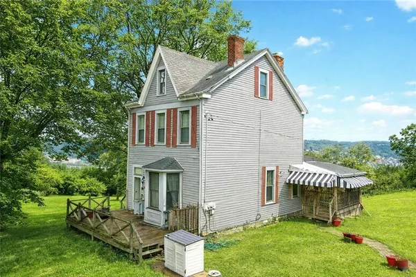 a view of a house with a yard and sitting area