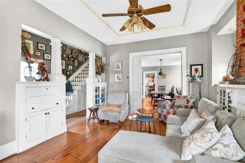a living room with furniture and wooden floor