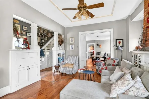a living room with furniture and wooden floor