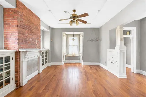 a view of an entryway with wooden floor