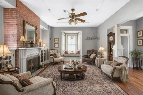 a living room with furniture chandelier and a fireplace