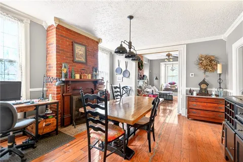a dining room with furniture and wooden floor