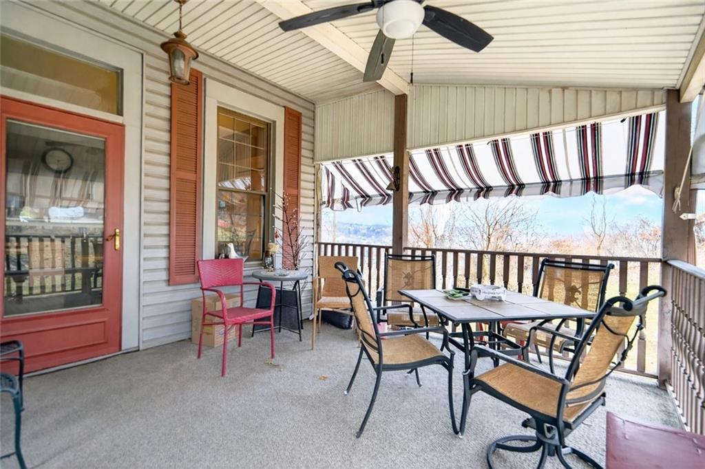 30 Perry Street Pittsburgh, PA 15209 - Photo 24 of 43 Step right outside the kitchen and onto this inviting covered deck—an ideal extension of your everyday living space. Perfectly positioned to capture peaceful outdoor views, this space offers the best of both comfort and scenery.