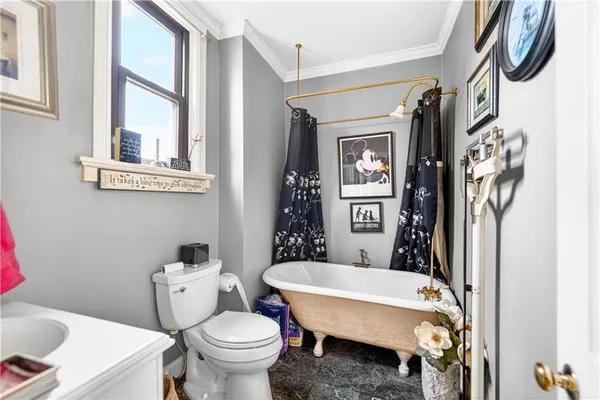 a bathroom with a toilet a sink and a mirror
