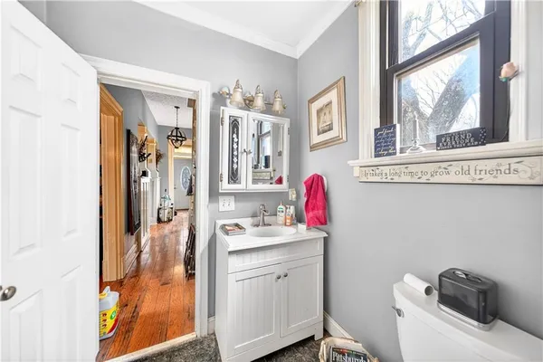 a bathroom with a sink vanity mirror and tub