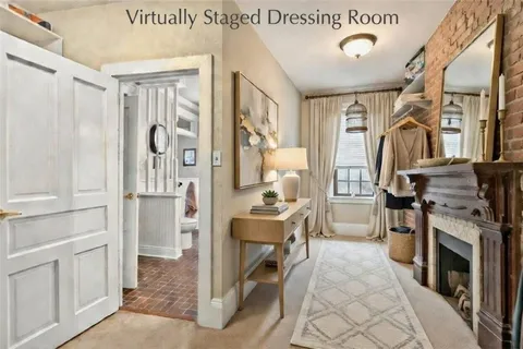 a living room with furniture a fireplace and a table