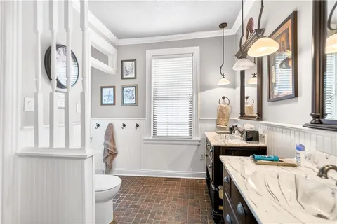 a bathroom with a sink a toilet and a mirror