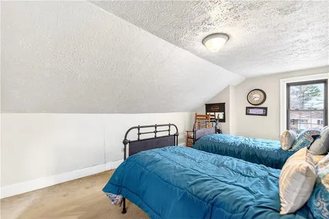 a bedroom with a bed and a lamp with window