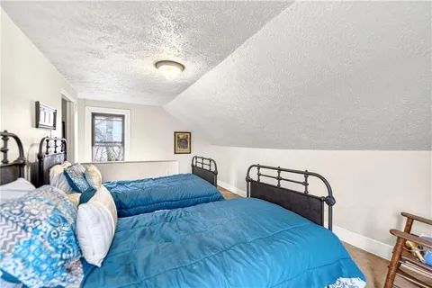 a bedroom with furniture and a window