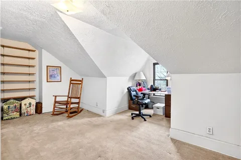 a view of a livingroom with furniture and a window