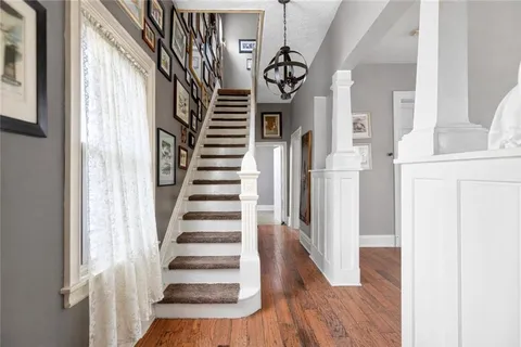 a view of entryway and hall with wooden floor