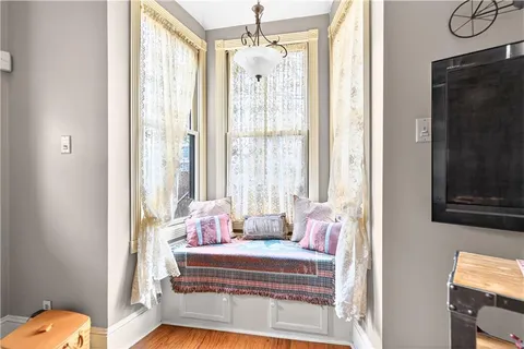 a bedroom with furniture and a window