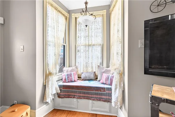 a bedroom with furniture and a window