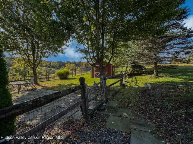 a view of a yard with wooden fence