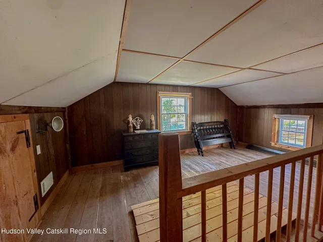 a view of a livingroom with furniture window and wooden floor