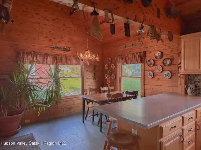 a view of a dining room with furniture and a window